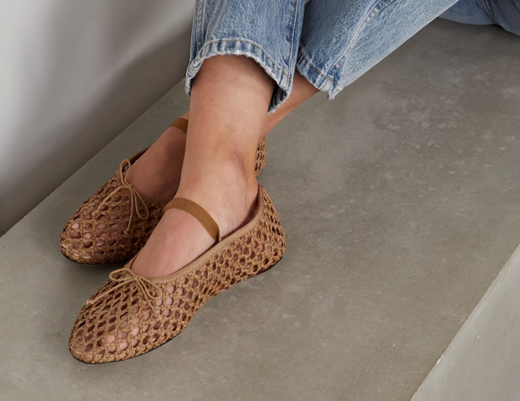 A pair of classic beige espadrille flats with a jute sole, perfect for casual summer outings and providing breathable comfort.